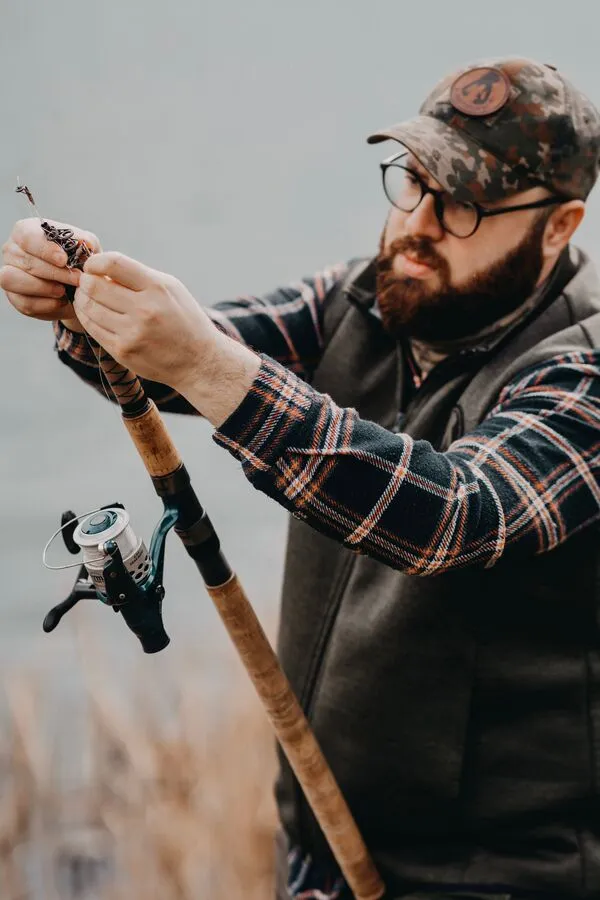 Northwater angler checking tackle beside the water